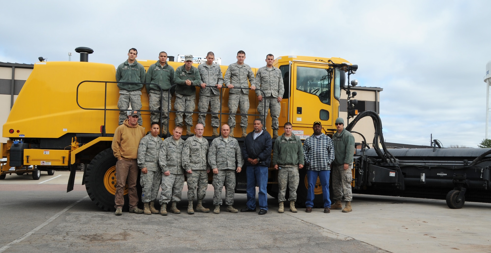 ALTUS AIR FORCE BASE, Okla. – Members of the 97th Civil Engineer Squadron heavy repair shop (Dirt Boyz), pose for a photo outside the pavements and equipment shop, April 18. The Dirt Boyz led the removal of rubber buildup on the assault strip caused by aircraft landings, so that the flying mission could continue. (U.S. Air Force photo by Airman 1st Class Franklin R. Ramos / Released)