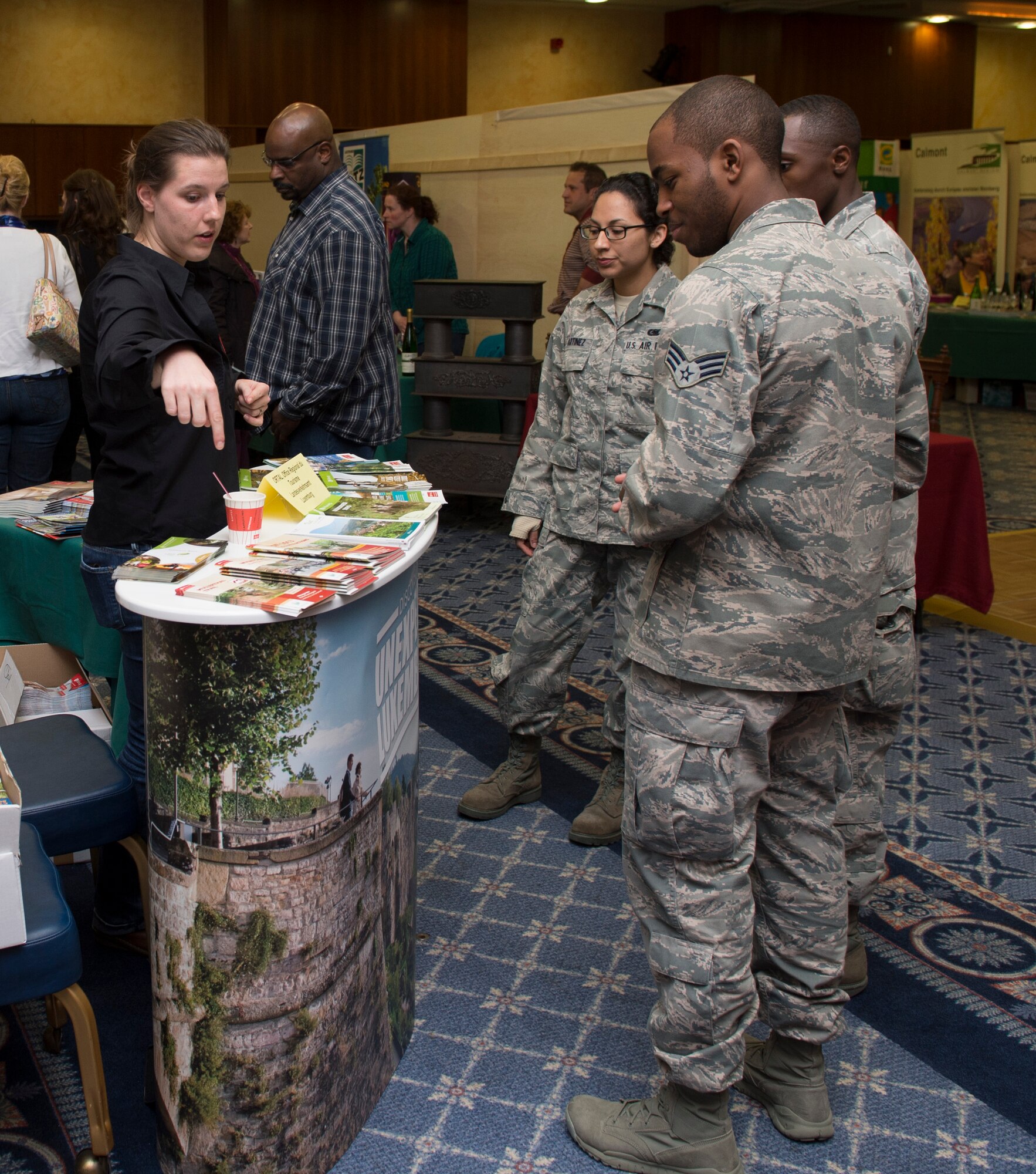 SPANGDAHLEM AIR BASE, Germany -- Stephanie Empain, Explore the Eifel vendor, tells Spangdahlem Airmen April 19, 2013, about unique opportunities in Luxembourg such as hiking. Explore the Eifel is an information fair that provides community members the opportunity to explore recreational activities the surrounding areas have to offer. (U.S. Air Force photo by Senior Airman Natasha Stannard/Released)