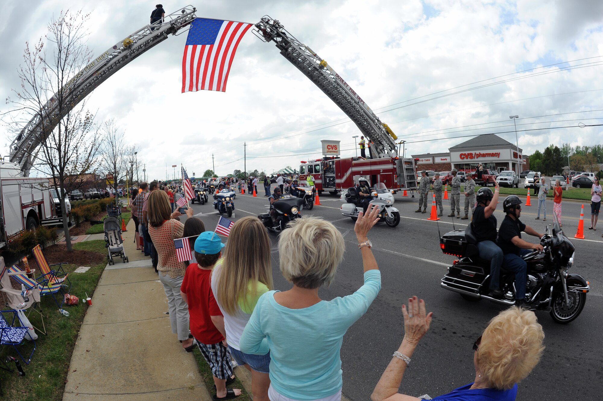 Citizens from across North Carolina wave as motorcyclists travel down Wayne Memorial Drive in Goldsboro, N.C., April 16, 2013. Hundreds of motorcyclists assisted in the escort of the Vietnam Veterans Memorial Traveling Wall to Wayne Community College. (U.S. Air Force photo by Airman 1st Class John Nieves Camacho/Released)