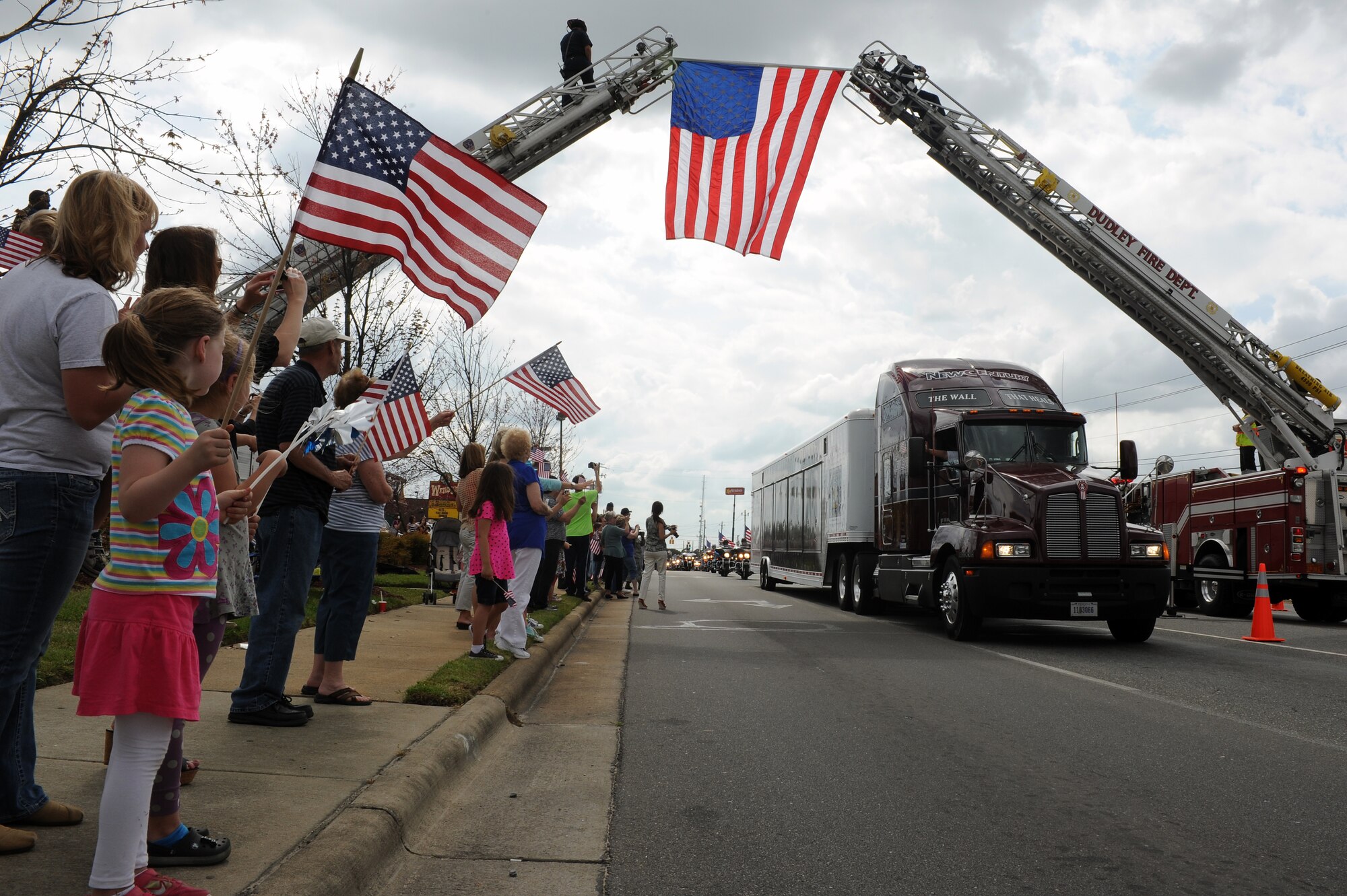 The Vietnam Veterans Memorial Traveling Wall passes through Wayne Memorial Drive in Goldsboro, N.C., April 16, 2013. Firefighters from the Dudley and Goldsboro fire departments created an archway with the American flag draped to welcome the wall to Goldsboro. (U.S. Air Force photo by Airman 1st Class John Nieves Camacho/Released)