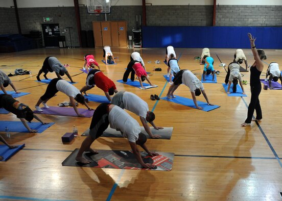 SOUTHWEST ASIA – Maj. Lucy Carillo, 379th Air Expeditionary Wing Judge Advocate, leads the Sunday evening yoga class at the Coalition Compound gym, April 14. The classes are free and open to all service members and civilians. The classes are available Sundays at 5 p.m. in the CC gym and at 7 p.m. Thursdays in the CC aerobic room.  (U.S. Air Force photo/Staff Sgt. Joel Mease)