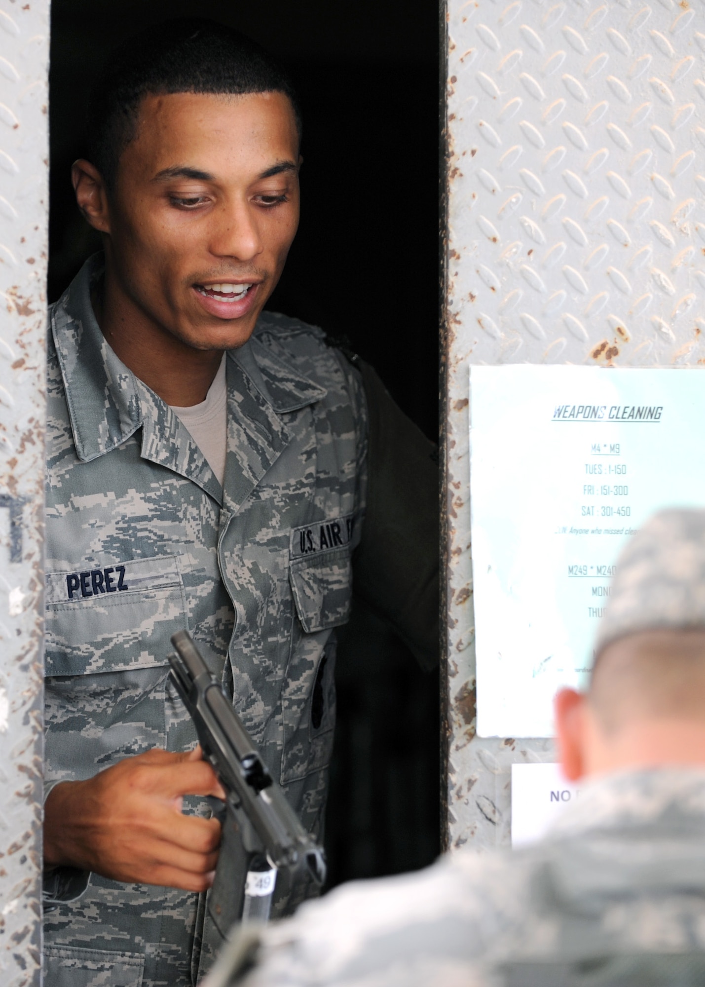 SOUTHWEST ASIA – Senior Airman SaMarre Perez, 379th Expeditionary Security Force Squadron, issues an M9 semiautomatic pistol to an Airman at the armory before the start of his shift, April 17. As a Defender, working the armory, Perez is required to authenticate each individual’s authorization to draw a firearm or ammunition at the time of issue. In addition, he is required to know if the member is not currently on the “do not arm list.” Perez is deployed from the 71st SFS at Andrews Air Force Base, Md. (U.S. Air Force photo/Staff Sgt. Joel Mease)