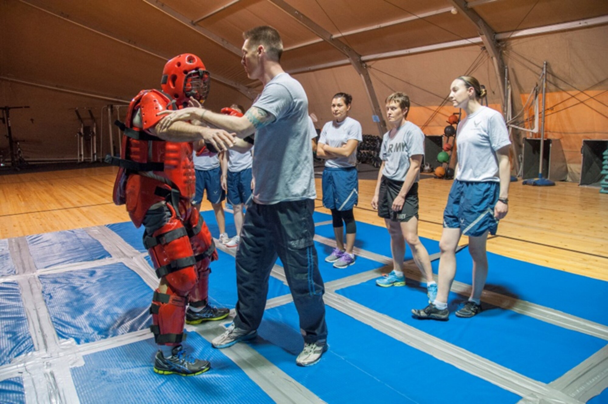 Air Force Office of Special Investigations agents in an undisclosed deployed location teach a women's self defense course during Sexual Assault Awareness Month. (U.S. Air Force photo)