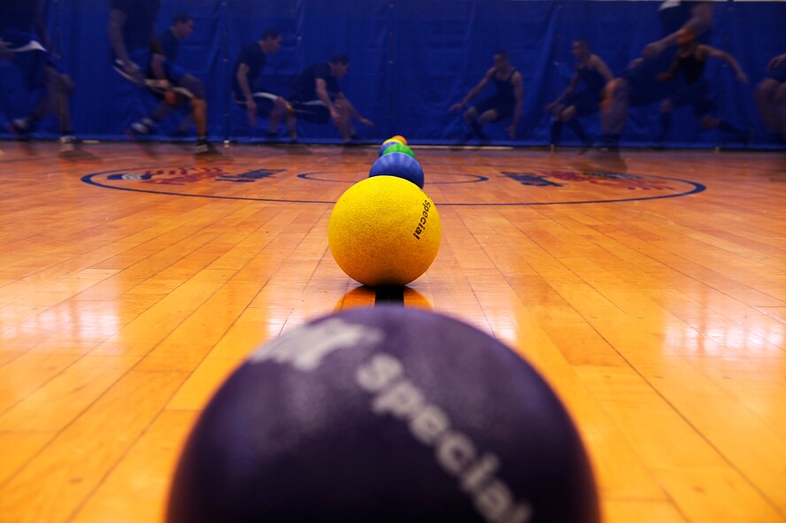 Participants in the Air Force Assistance Fund Sports Day competition run to retrieve dodge balls from the center of the court at the Risner Fitness Center on Kadena Air Base, Japan, April 12, 2013. Twelve teams comprised of 50 people gathered at the Risner for the event, which raised roughly $500 for the AFAF. (U.S. Air Force photo by Senior Airman Maeson L. Elleman/Released)