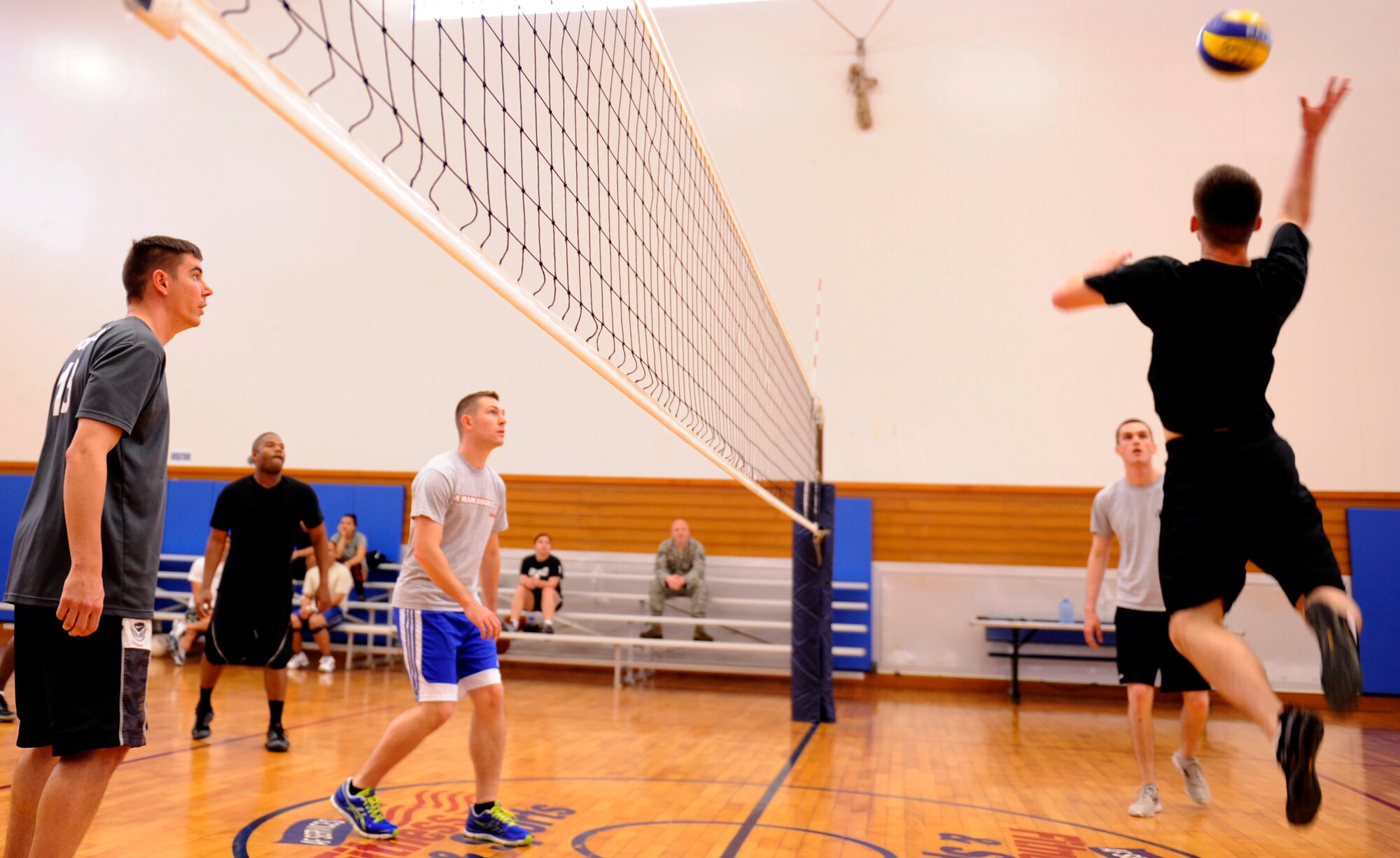 A participant in the Air Force Assistance Fund Sports Day tournament jumps to spike a volleyball at the Risner Fitness Center on Kadena Air Base, Japan, April 12, 2013. During the event, teams from all around the base donated to the AFAF for their chance to dominate the courts in each of the tournament?s separate competitions. (U.S. Air Force photo by Senior Airman Maeson L. Elleman/Released)