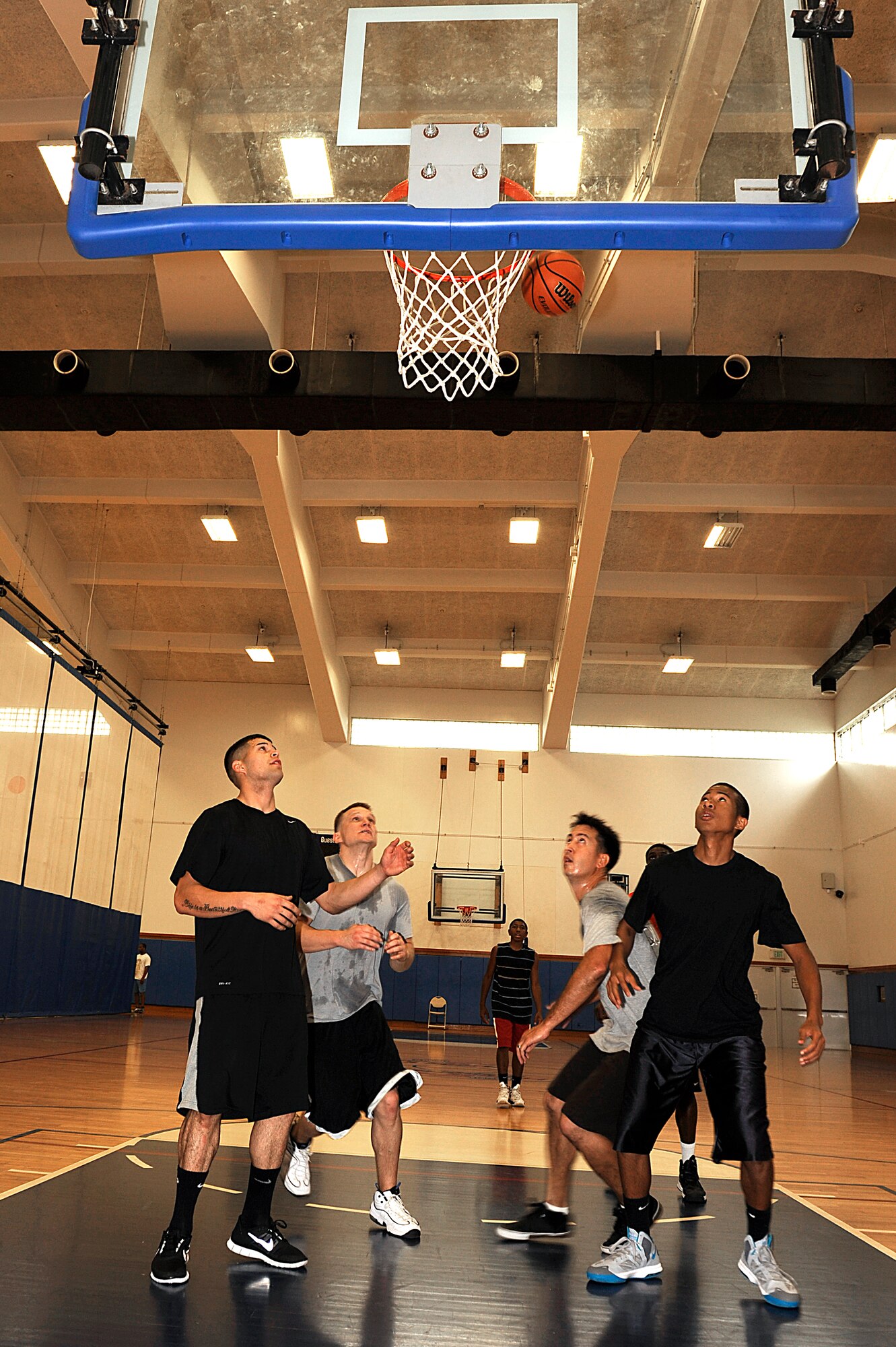 Participants in the Air Force Assistance Fund Sports Day tournament play basketball during the event at the Risner Fitness Center on Kadena Air Base, Japan, April 12, 2013. Twelve teams comprised of 50 people gathered at the Risner for the event, which raised roughly $500 for the AFAF. (U.S. Air Force photo by Senior Airman Maeson L. Elleman/Released) 