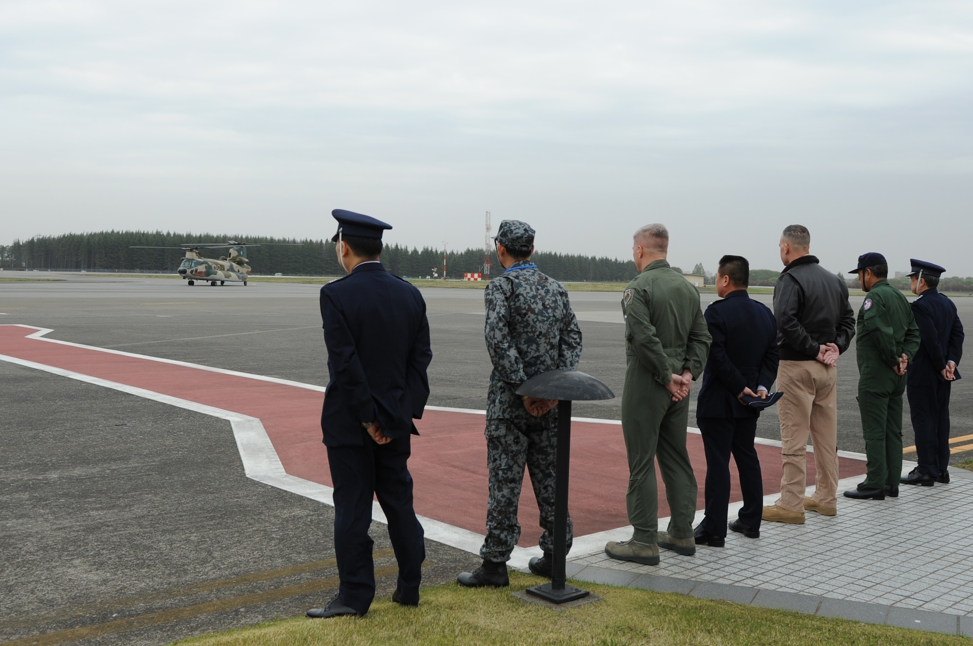 YOKOTA AIR BASE, Japan -- Military leaders from U.S. Forces, Japan, 5th Air Force, the 374th Airlift Wing and the Japan Self-Defense Force await the arrival of the Japan Minister of Defense, Itsunori Onodera, April 19, 2013, at Yokota Air Base, Japan. The Minister of Defense stopped at Yokota for a brief visit to the Japan Air Defense Command Headquarters. The Air Defense Council headquarters relocated to Yokota in 2012 to enable the U.S. Air Force and Japan Self-Defense Force alliance to have fewer barriers to effective communication and improve bilateral interoperability, contingency planning, training and cultural understanding.  (U.S. Air Force photo by Airman 1st Class Desiree Economides)