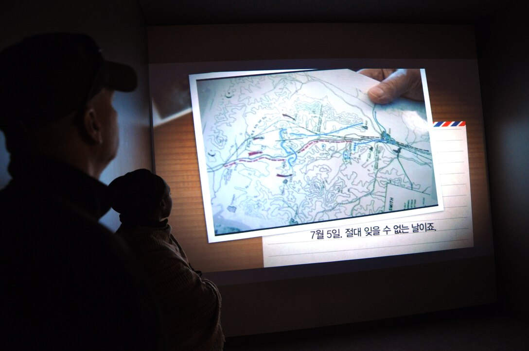 Military members of the Far East District watch a video about the first encounter between U.S. and North Korean forces during the Korean War Friday, April 19, at the Task Force Smith museum, located about 25 miles south of Seoul near the city of Osan.  The new museum, which officially opens in late April, is dedicated to Task Force Smith, the unit which felt the brunt of the North Korean advance towards would become the Pusan Perimeter. The Soldiers toured the museum and did a terrain walk over the battlefield, which still is used by the Republic of Korea army for training. There are still depressions in the hill's surface where Task Force Smith's fighting positions once were.