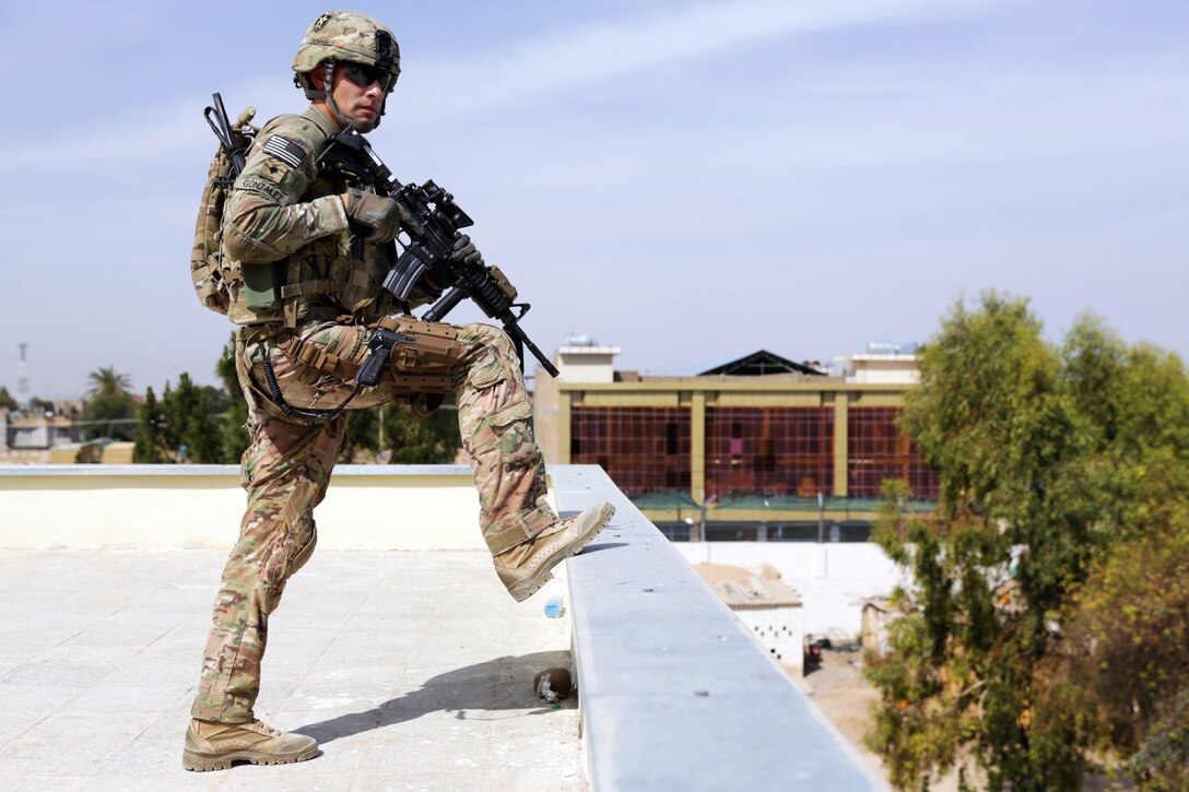 U.S. Army Spc. Joseph Gonzalez provides rooftop security during a meeting with the Farah provincial council at the governor's compound in Farah City, Afghanistan, April 18, 2013. Gonzalez is assigned to Provincial Reconstruction Team Farah.