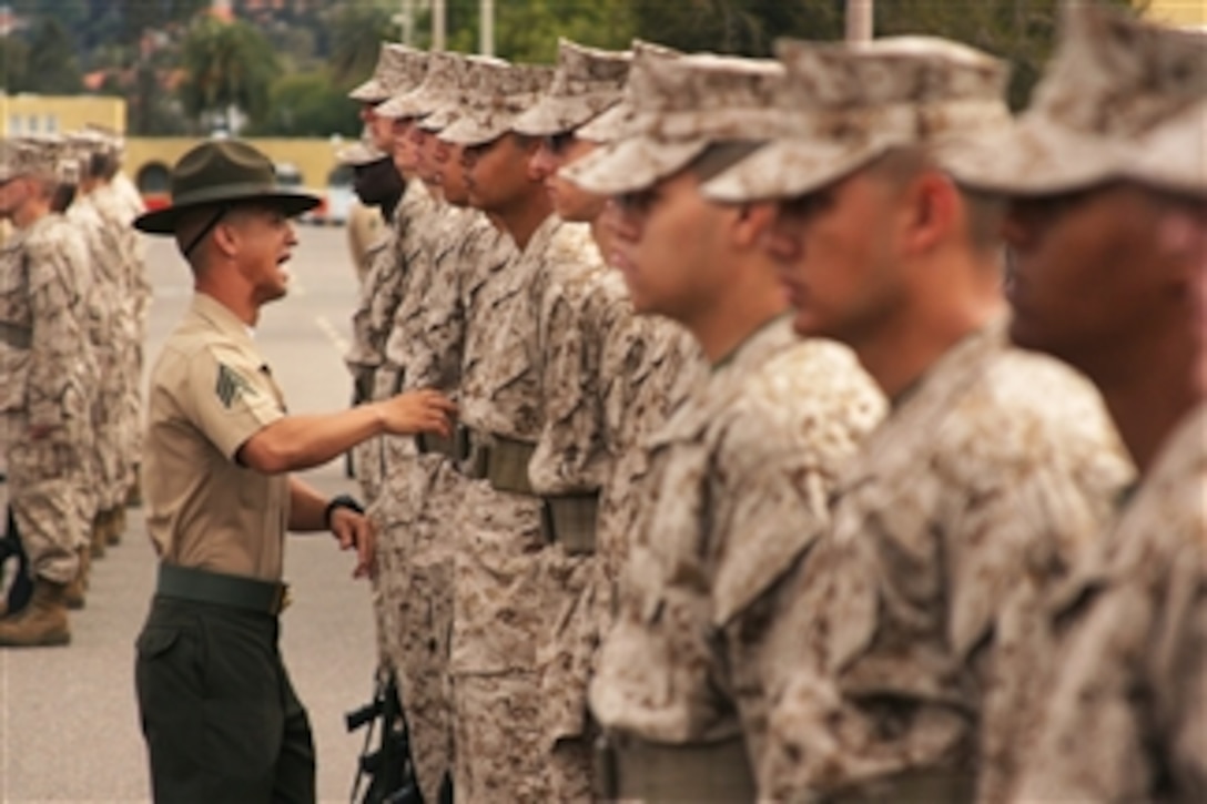 Marine recruits of Company A, 1st Recruit Training Battalion, stand in formation for a uniform inspection by a senior drill instructor at Marine Corps Recruit Depot San Diego, Calif., on April 5, 2013.  Examination of the recruit’s uniforms, weapons, and Marine Corps knowledge are some of the items drill instructors test during inspection. 