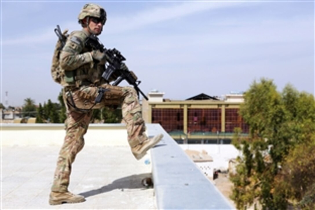 U.S. Army Spc. Joseph Gonzalez provides rooftop security during a meeting with the Farah provincial council at the governor's compound in Farah City, Afghanistan, April 18, 2013. Gonzalez is assigned to Provincial Reconstruction Team Farah. 
