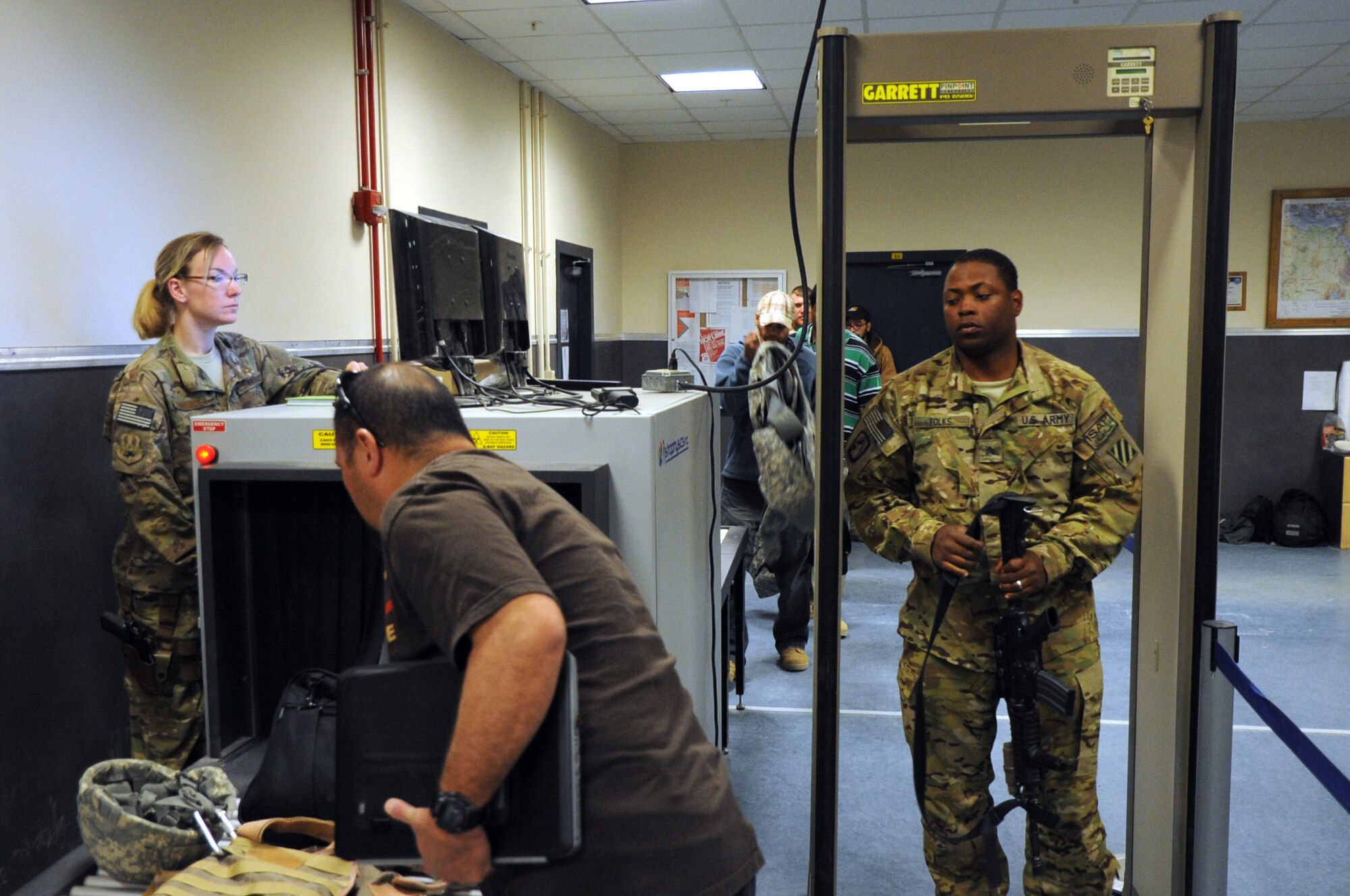 Staff Sgt. Genie Spencer, 455th Expeditionary Aerial Port Squadron passenger service superintendent, screens passengers for a flight at the passenger terminal on Bagram Airfield, Afghanistan, April 19, 2013. The 455th EAPS recently rearranged the terminal layout to bolster the security process. (U.S. Air Force photo/Staff Sgt. David Dobrydney)