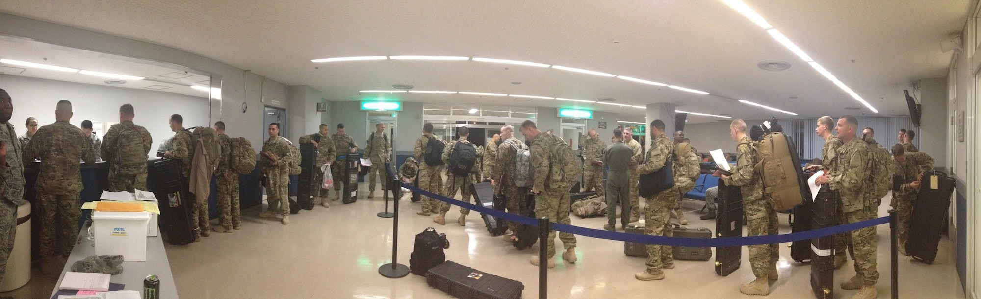 Kadena service members process through a personnel deployment function line at the passenger terminal on Kadena Air Base, Japan. The PDF line is a fast and efficient way for base agencies to outprocess a large number of people for deployment. (U.S. Air Force photo by Senior Airman Stephen Brasher/Released)