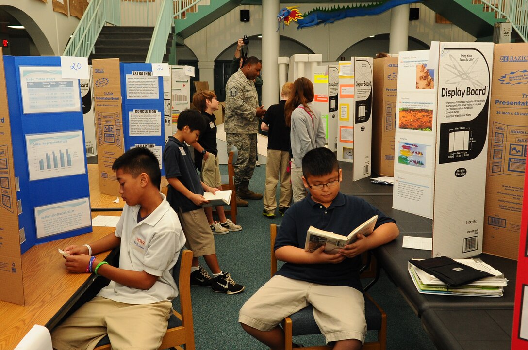 Andersen Middle School students read books and flash cards before presenting their science fair projects to judges on Andersen Air Force Base, Guam, April 4, 2013. The science fair showcased the students’ creativity and scientific knowledge. (U.S. Air Force photo by Airman 1st Class Adarius Petty/Released)