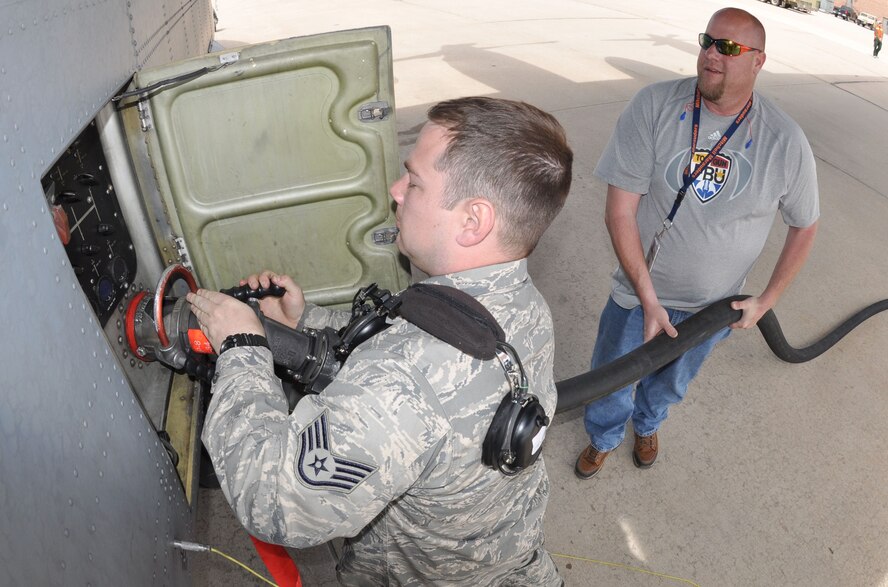 Air Force Reserve Staff Sgt. Sean Macca, a C-130 Hercules crew chief, works with base fuels personnel to refuel a 302nd Airlift Wing C-130 Hercules April 21, 2013 at Peterson Air Force Base, Colo. Macca, together with other 302nd AW members supported the 302nd Airlift Wing's annual Modular Airborne Firefighting System, or "MAFFS" certification and re-certification program April 19-23 here. The wing, an Air Force Reserve organization, receives certification or re-certification from the U.S. Forest Service each year, ensuring the organization is prepared to respond to wildland forest fires at a moment's notice. Macca is assigned to the 302nd Aircraft Maintenance Squadron. (U.S. Air Force photo/Tech. Sgt. Stephen J. Collier)