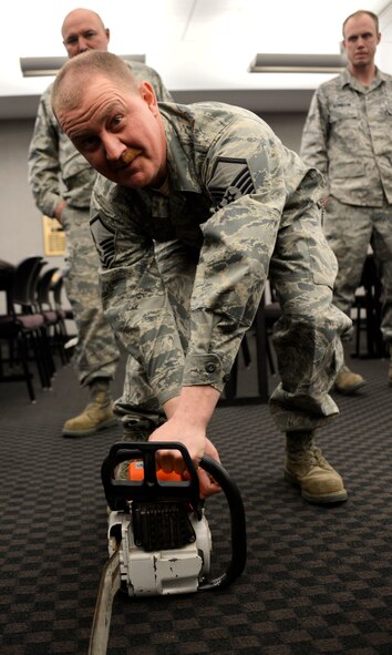 Master Sgt. Steven Virnig, 133rd Civil Engineering Squadron, gets familiar with the chainsaw at St. Paul Minn., Apr. 20, 2013. 
U.S. Air Force photo by Staff Sgt. Austen Adriaens/released 
