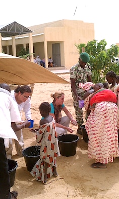 During a cholera outbreak in Mali in 2011, 193rd Special Operations Medical Group personnel Major Plante (left) and Capt. Cindy Innella explain hand-washing techniques and hygiene to visitors during a scheduled village medical encounter.