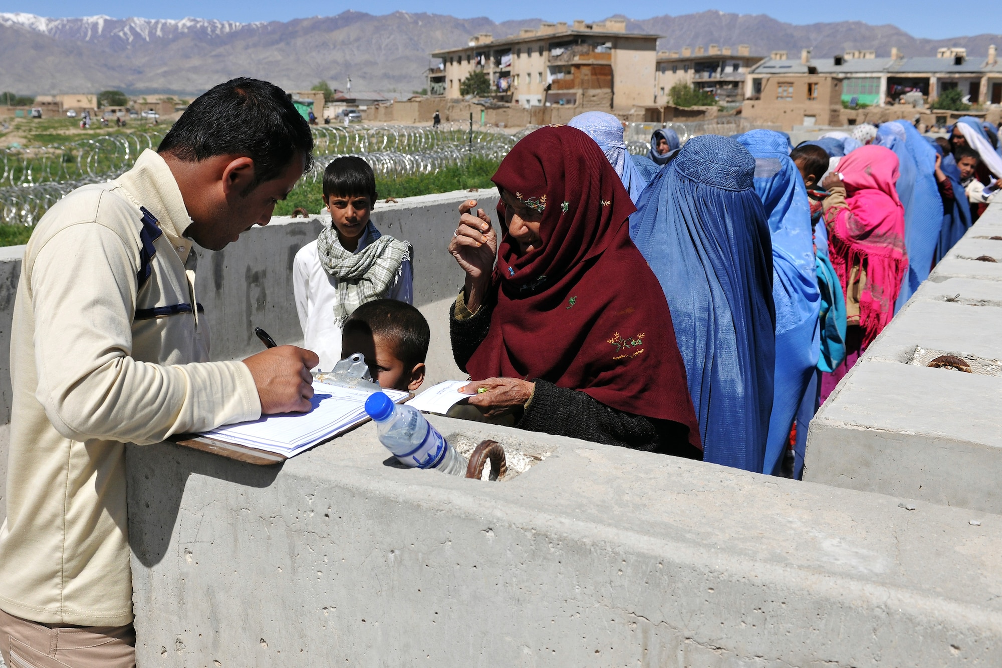 Local Afghans wait to process through the medical entry control point at Bagram Airfield, Afghanistan, April 16, 2013.  Members of the 455th Expeditionary Security Forces Squadron and Afghan local guards process as many as 500 people from outside the gate needing services ranging from basic clinical care to student vocational programs.  (U.S. Air Force photo/Senior Airman Chris Willis)