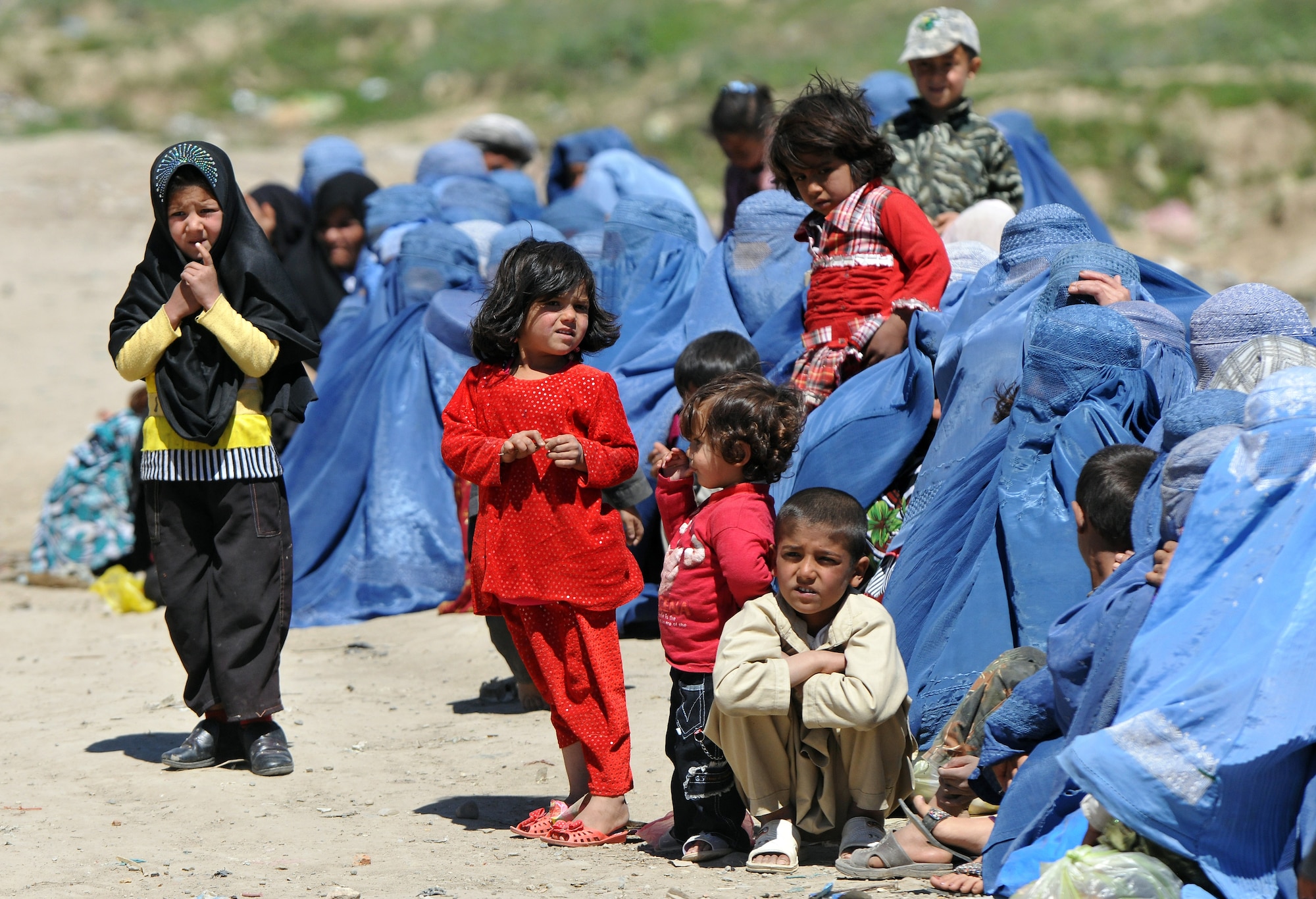 Local Afghans wait to process through the medical entry control point at Bagram Airfield, Afghanistan, April 16, 2013.  Members of the 455th Expeditionary Security Forces Squadron and Afghan local guards process as many as 500 people from outside the gate needing services ranging from basic clinical care to student vocational programs.  (U.S. Air Force photo/Senior Airman Chris Willis)