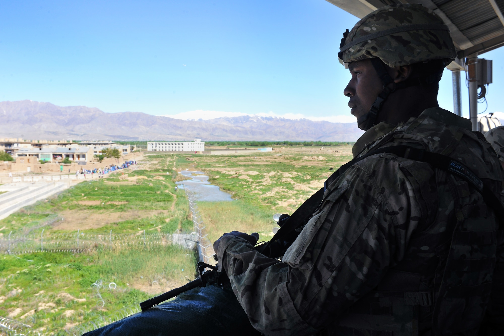 Tech. Sgt. Travis Simpson, 455th Expeditionary Security Forces Squadron entry controller, carefully monitors the area outside the medical entrance control point at Bagram Airfield, Afghanistan, April 16, 2013.  The 455th ESFS teams patrol the base perimeter looking for suspicious activities while local Afghan civilians arrive to receive basic medical care.  (U.S. Air Force photo/Senior Airman Chris Willis)