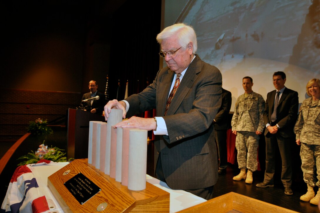 U.S. Rep. Congressman Hal Rogers of Kentucky 5th District places the final placement of a scale pile model cast of the Foundation Remediation Concrete pile that was cast from final barrier wall concrete placment on March 6, 2013 at a Completion Ceremony of rehabilitation work for the Wolf Creek at the Russell County schools Auditorium/Natatorium April 19, 2013.