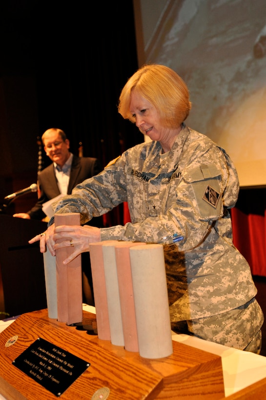 Brig. Gen. Margaret Burcham, U.S. Army Corps of Engineers Great Lakes and Ohio River Division commander, places a piece of the placement of a scale pile model cast of the Foundation Remediation Concrete pile that was cast from final barrier wall concrete placement on March 6, 2013 at a Completion Ceremony of rehabilitation work for the Wolf Creek at the Russell County schools Auditorium/Natatorium April 19, 2013.  The Wolf Creek Dam remediation project is considered a model project and the largest project of its kind in the world.