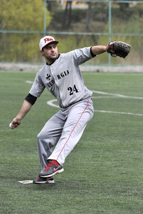 A player from the Republic of Georgia National baseball team throws a ball during a recent game against U.S. Marines assigned to the Georgia Training Team. The teams faced off to honor the Georgian wounded warriors. The game ended with the Georgian National Team edging out the win. 