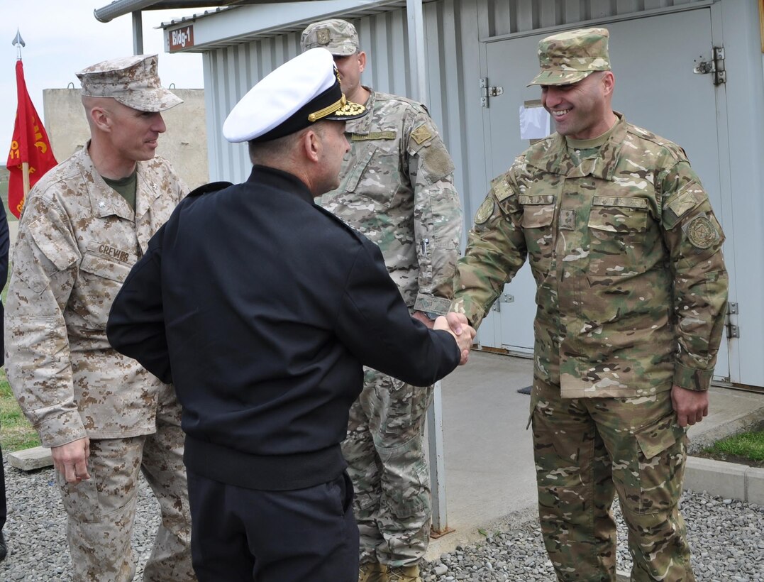 Admiral James G. Stavridis, the supreme allied commander for Europe and commander of U.S. European Command shakes hands with a Georgian Lt. Col. in charge of Georgian soldiers working with the U.S. Marines assigned to the Georgia Training Team during a tour to visit U.S. personnel currently working with the Republic of Georgia armed forces and government agencies.