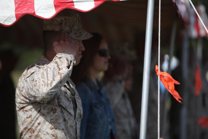 Sgt. Maj. John E. Bankus, the outgoing sergeant major of 8th Engineer Support Battalion, salutes the colors during the national anthem during a relief and appointment ceremony held by the battalion aboard Camp Lejeune, N.C., April 18, 2013. During his tour, Bankus deployed with the battalion in 2012 and supported Hurricane Sandy relief efforts with 8th ESB. 