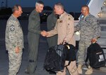 Maj. Gen. Robert A. Knauff, commander of the New York Air National Guard and Air Guard assistant to the commander, Air Force Special Operations Command, and Command Chief Master Sgt. David Heckman of the 174th Fighter Wing welcome home Lt. Col. David Brenton and Chief Master Sgt. Michael Will at Hancock Field Air National Guard Base in Syracuse, N.Y., Aug. 5. The 174th deployed for Operation Iraqi Freedom in early June. It was the last overseas deployment for the wing's F-16 Fighting Falcons. The wing is transitioning into its new MQ-9 Reaper unmanned aerial vehicle mission.