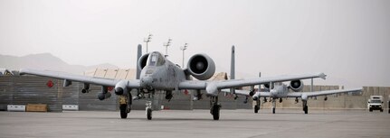 Two A-10 Thunderbolt II jets taxi out to the runway July 26 at Bagram Airfield, Afghanistan. The jets are experts at close air support missions and have proven to be invaluable despite being well past their expected useful lifespan.