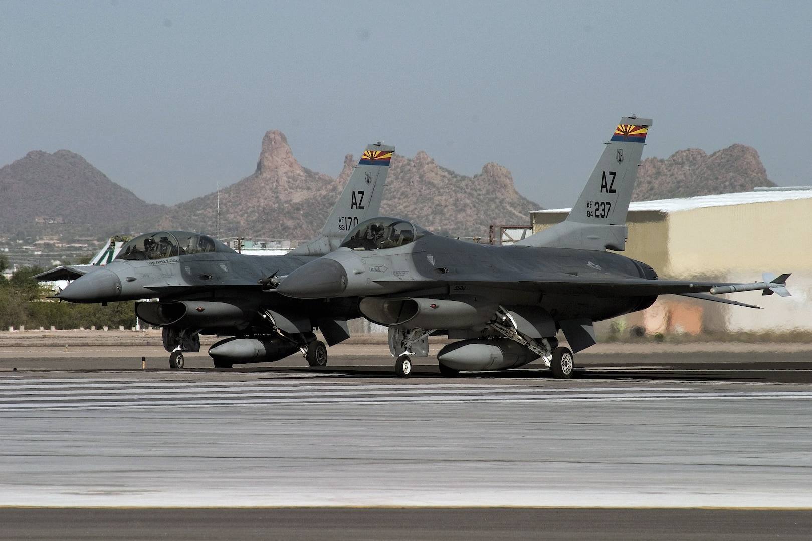 From the end of the runway at Tucson International Airport, an F-16 Fighting Falcon instructor pilot with the Arizona Air National Guard's 162nd Fighter Wing prepares to take off with his wingman, an international student pilot training with the Guard unit.