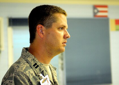 Capt. Paul Ferguson Jr., of the Texas Air National Guard listens to patients at the Bobby Benson Center in Kahuku, Hawaii. Ferguson is part of a 51-person group of physicians, nurses and support personnel from the 149th Fighter Wing Medical Group in San Antonio, Texas working with the Hawaii ANG in support of the E Malama Kakou (To care for all) humanitarian program serving the medically underprivileged in Hawaii.