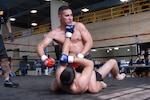 Mitchell Thomas IV: Sgt. Robert Encino and Sgt. Ken Browne wildly throw punches at each other during their Lightweight final match Sunday.