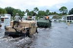Members of the Florida National Guard's Delta Company, 1st Battalion, 124th Infantry Regiment, enter the Lamplighter Village mobile home park in Melbourne, Fla., to evacuate residents who request it, Aug. 21, 2008. Several residents were transported out of the park over the course of the day.