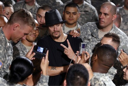 Kid Rock poses with Army National Guard soldiers after filming the "Warrior" video, which will premiere in more than 3,000 theatres around the country on Aug. 22.