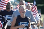 Army National Guard Staff Sgt. Rebecca Ingram nears the finish of the national Run for the Fallen's final 10-kilometer leg at Arlington National Cemetery on the morning of Aug. 24.