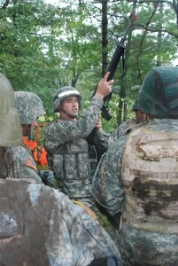 Cpl. Nicholas Sbano, a New York Pre-Mobilization Assistance Element Observer Controller/Trainer, discusses proper procedures before moving deploying Soldiers through a barbed wire obstacle course at Ft. Drum on August 8, 2008.