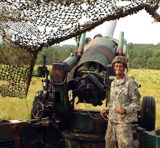 Staff Sgt. Crooks prepares to fire a final ceremonial howitzer round while the Battery C, 2nd Battalion, 123rd Field Artillery performed Annual Training at Fort McCoy, Wis. in July 2008.