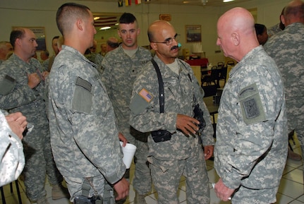 Sergeant First Class Thomas Deis from Ithaca, NY assigned to SECFOR D (security force Company D) 2nd Squadron 101st Cavalry, New York Army National Guard speaks with Lt. Gen. Blum at the conclusion of an open forum meeting.