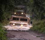 Soldiers from 2nd Battalion, 124th Infantry Regiment make their way through a washed out section of roadway while assisting search and rescue teams help citizens trapped in their homes by flood waters caused by Tropical Storm Fay. The Florida National Guard currently has nearly 500 Soldiers and Airmen assisting with recovery and logistical operations in the wake of Tropical Storm Fay.