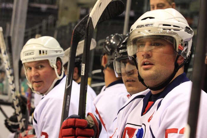 Patriots Hockey team members catch their breath on the bench and watch their teammates during a game against the Los Angeles County Sheriff's Department at the STAPLES Center here, April 18, 2013. Patriots Hockey is a team dedicated to serving the military community and wounded warriors by raising funds and awareness for nonprofit organizations. The team raised money for the Semper Fi Fund by selling t-shirts, jerseys and other Patriots Hockey gear at the STAPLES Center that evening.