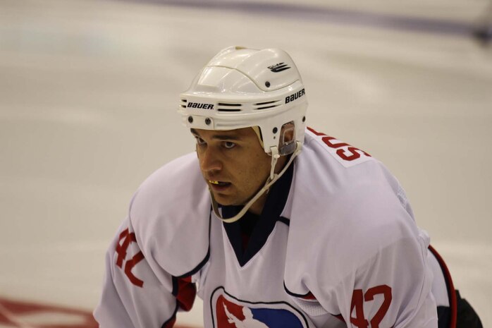 Patriots Hockey team player Jacob Sorenson, a former Marine who served with 1st Battalion, 7th Marine Regiment, catches his breath during a game against the Los Angeles County Sheriff's Department at the STAPLES Center here, April 18, 2013. Patriots Hockey is a team dedicated to serving the military community and wounded warriors by raising funds and awareness for nonprofit organizations. The team raised money for the Semper Fi Fund by selling t-shirts, jerseys and other Patriots Hockey gear at the STAPLES Center that evening.