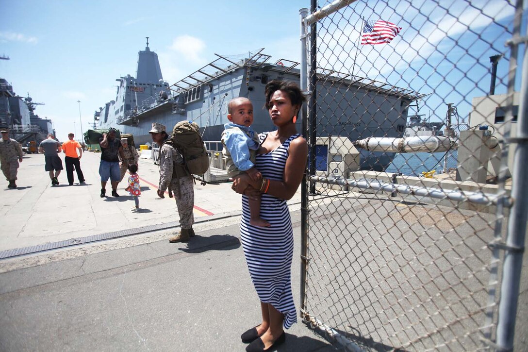 Families of Marines and sailors with 1st Marine Logistics Group, 1st Marine Division and 3rd Marine Aircraft Wing accompany their loved ones as they prepare to board the Navy's newest amphibious transport dock ship, the USS Anchorage, at Naval Base San Diego, April 21, 2013. The ship left San Diego April 22, and is scheduled to be formally commissioned in Anchorage, Alaska, May 4. (U.S. Marine Corps photo by Cpl. Laura Gauna/Released)