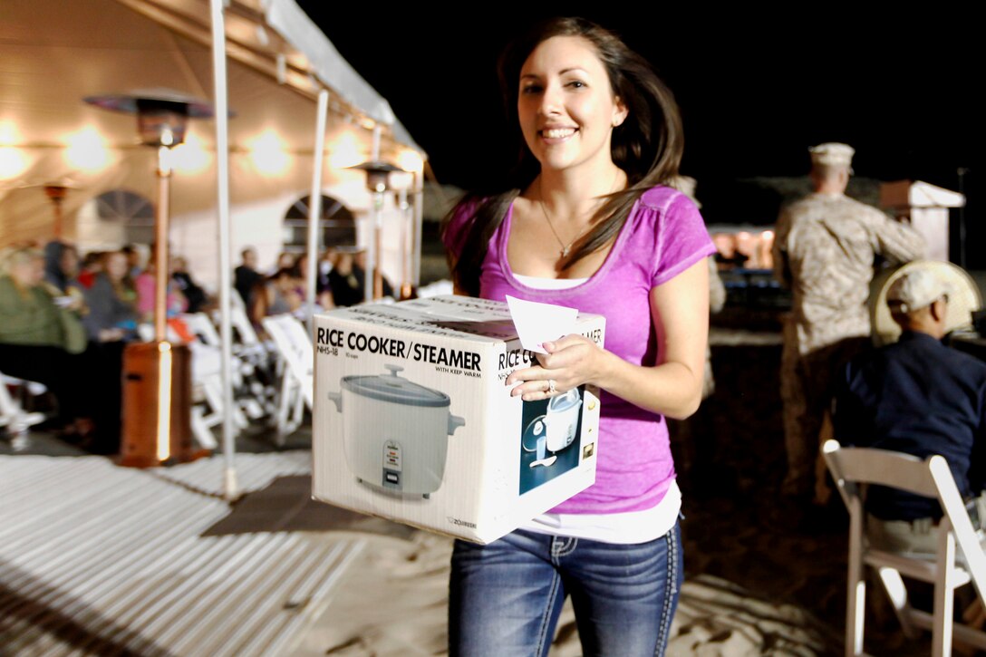 Amber Cousino won a rice cooker during the raffle at the Live, Laugh and Learn event at the Del Mar Beach Resort here April 19. The  tour features motivational presentations, book signing and author meet and greet events for military wives. 


