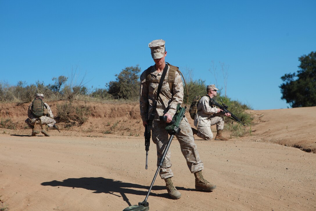 Private First Class Taylor Butler, a combat engineer with Bravo Company, 7th Engineer Support Battalion, 1st Marine Logistics Group, sweeps for simulated improvised explosive devices and mines during a field training exercise aboard Camp Pendleton, Calif., April 19, 2013. The Marines spent the day training with the latest minesweeping equipment. (U.S. Marine Corps photo by Lance Cpl. Cody Haas/Released)