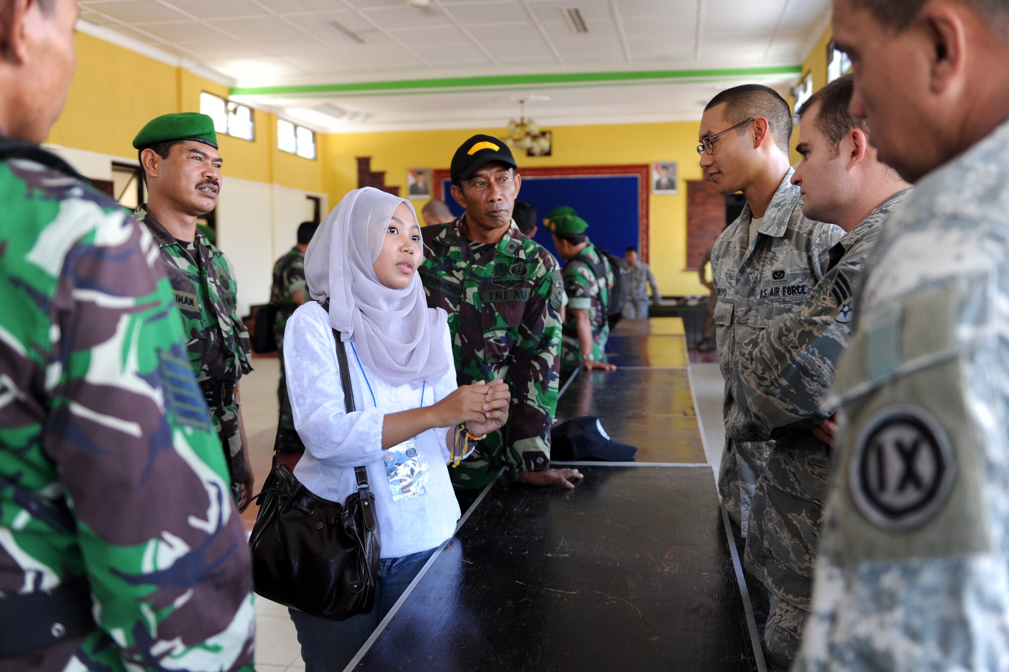 U.S. service members and members of the Indonesian Armed Forces talk via an interpreter during Pacific Angel 13-2 at Yogykarta, Republic of Indonesia, April 22, 2013. PACANGEL is a joint and combined humanitarian assistance exercise held in various countries several times a year and includes medical, dental, optometry, engineering programs and various subject-matter expert exchanges. (U.S. Air Force photo by Airman 1st Class Kia Atkins) 