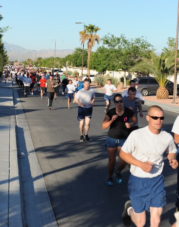 Approximately 450 runners hit the halfway mark of the Survive and Thrive 5-kilometer run April 19, 2013, at Nellis Air Force Base, Nev. The run was organized to raise awareness of mental health programs offered to Nellis Airmen, as well as sexual assault prevention courses. (U.S. Air Force photo by Benjamin Newell) 