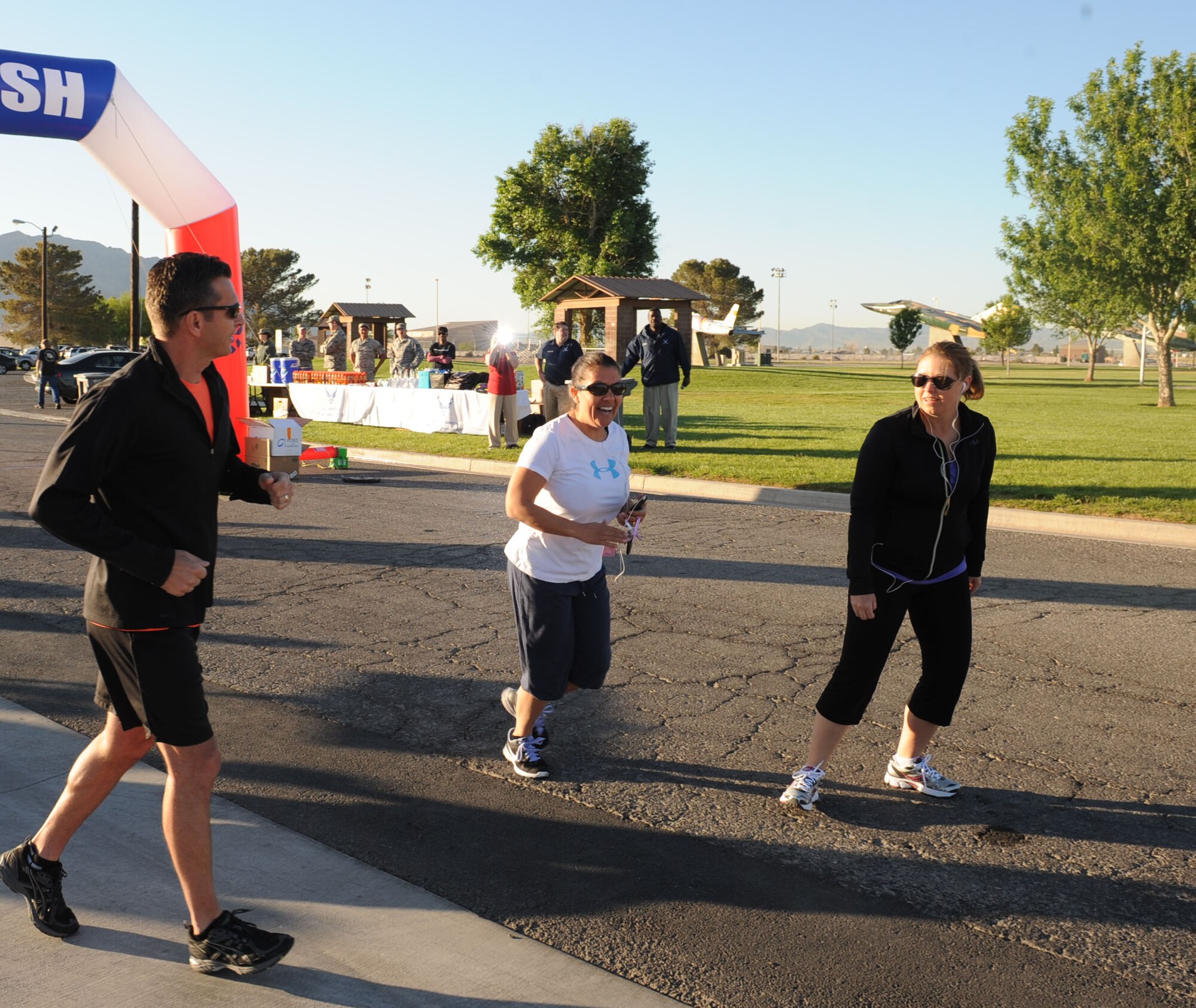 Col. Barry Cornish, 99th Air Base Wing commander, and members of the 99th Air Base Wing Staff Agency begin the Survive and Thrive 5-kilometer run April 19, 2013, at the Warrior Fitness Center at Nellis Air Force Base, Nev. The run was organized to promote sexual assault prevention and raise awareness for mental health programs offered to Nellis Airmen.  (U.S. Air Force photo by Benjamin Newell) 