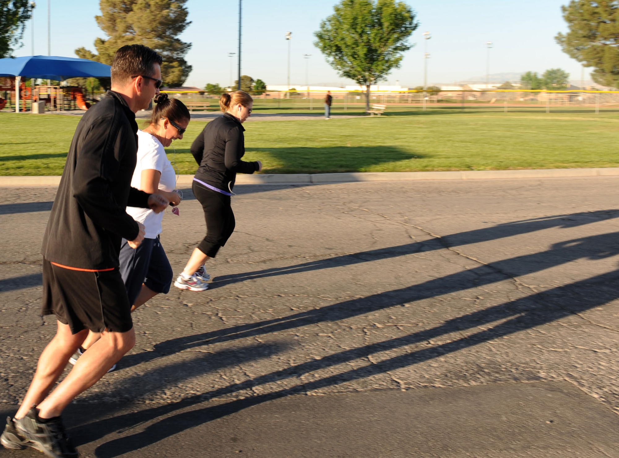 Col. Barry Cornish, 99th Air Base Wing commander, and members of the 99th Air Base Wing Staff Agencies begin the Survive and Thrive 5-kilometer run at the Warrior Fitness Center April 19, 2013, at Nellis Air Force Base, Nev. The run was organized to promote sexual assault prevention and raise awareness for mental health programs offered to Nellis Airmen.  (U.S. Air Force photo by Benjamin Newell) 
